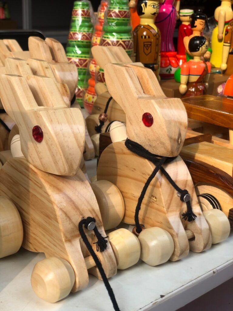 a couple of wooden rabbits sitting on top of a table